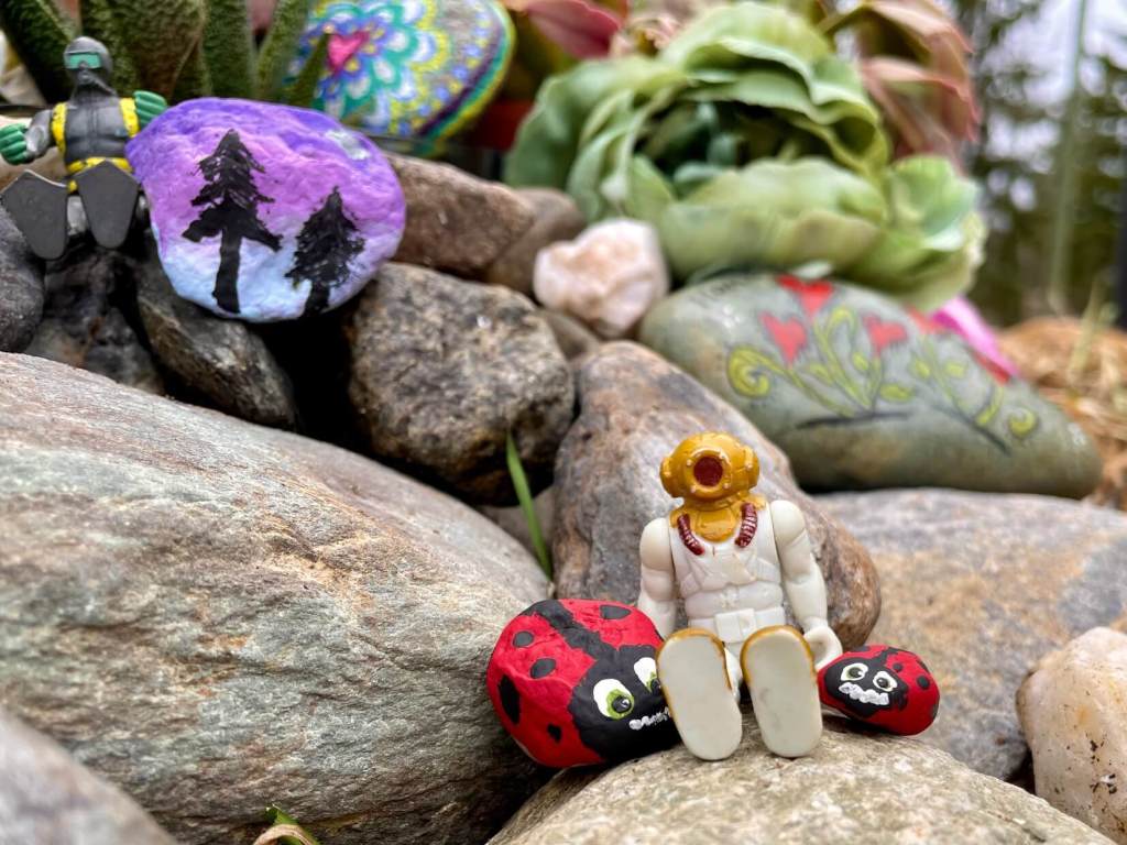 Small toys with lady bugs and sunset themed Remembering Rocks