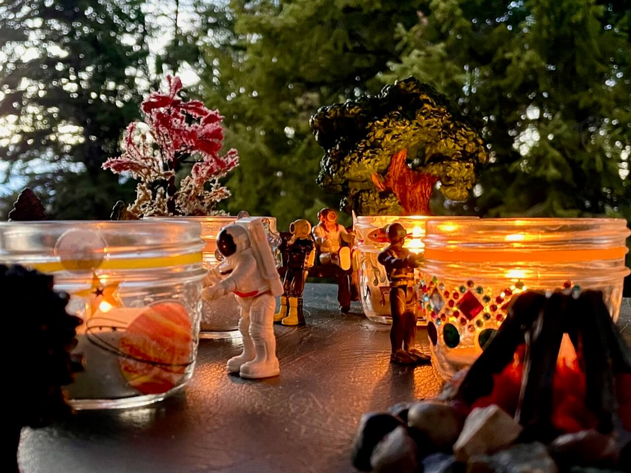 Small toys looking at their Memory Lanterns in nature