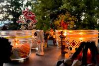 Small toys looking at their Memory Lanterns in nature