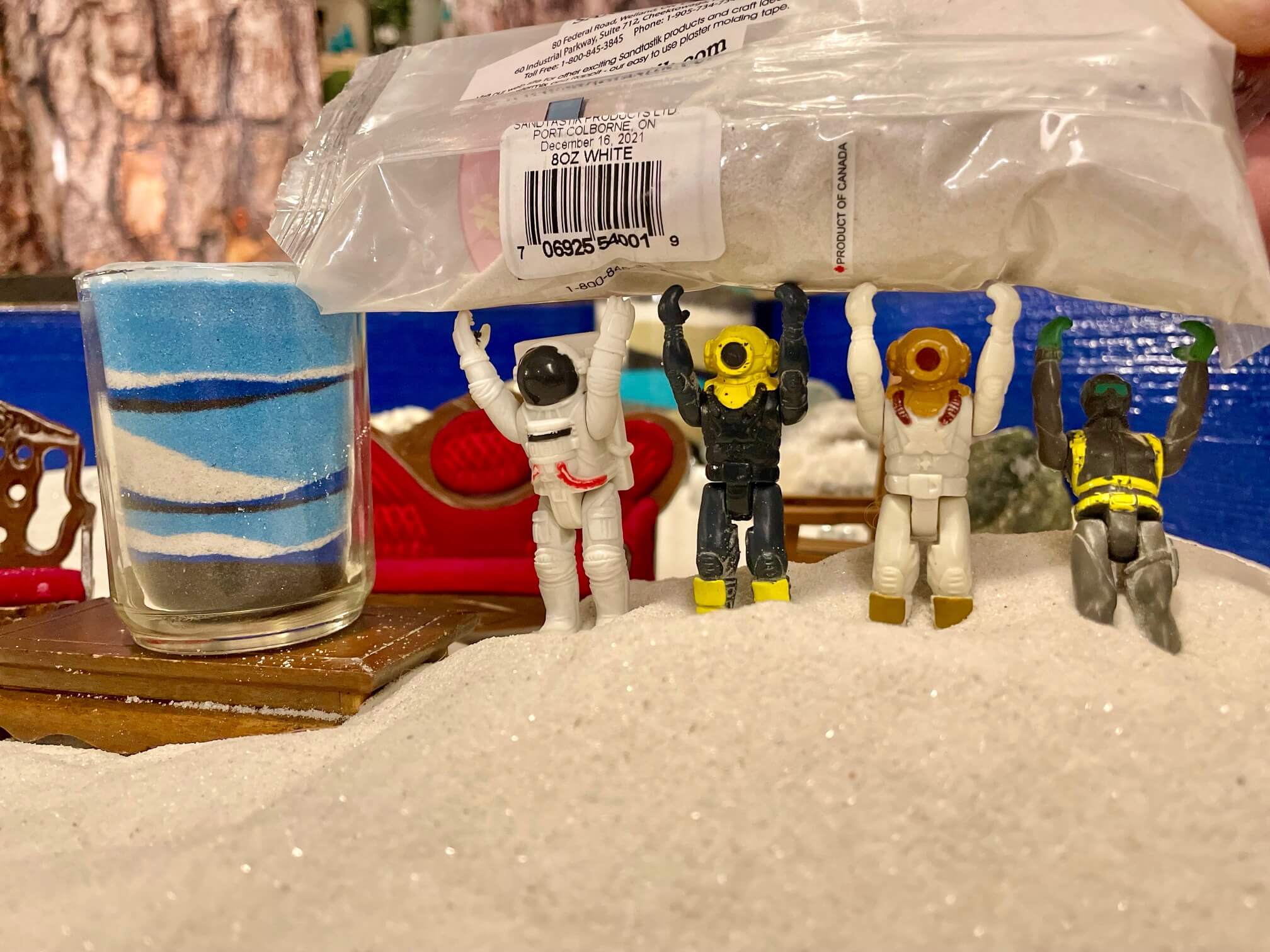 Small toys adding a layer of sand into their Layers of Love