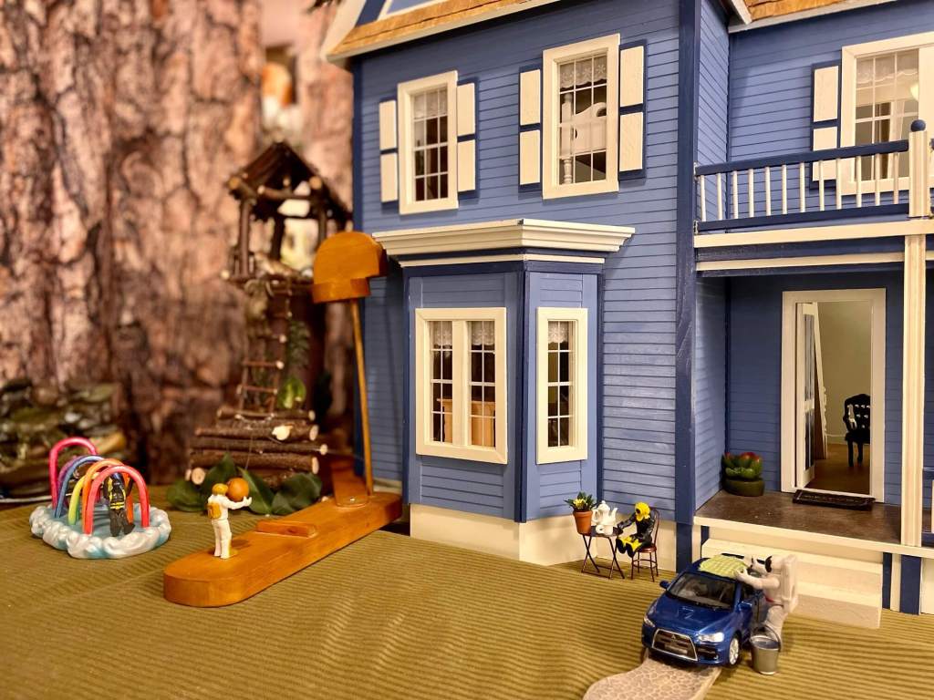 Family of toys all doing their own thing; washing a car, enjoying tea, playing on the playground, and playing basketball