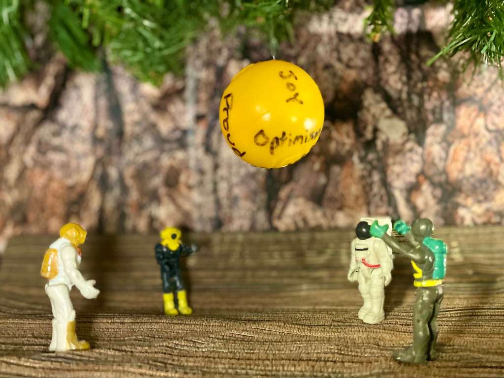 4 toys in a tree in a grief group tossing the beach ball of emotions back and forth