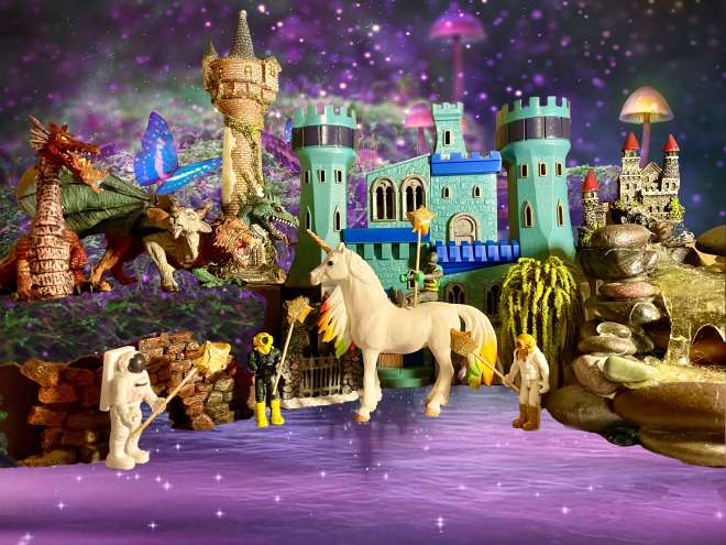 4 toys holding magic wands with a unicorn, dragons, castles, willow tree, and a wishing well